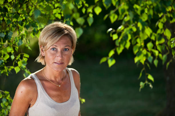 istock woman under a tree outdoor 1137890600