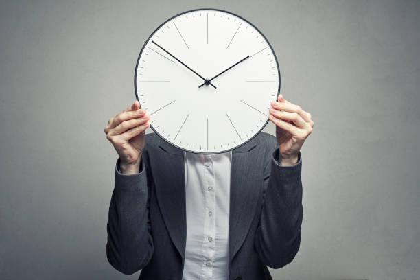 istock business woman covering her face with clock 1137891395