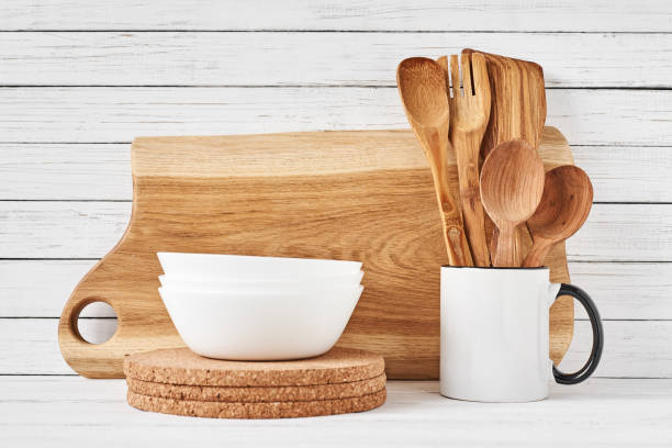 istock Cooking utensils and cutting board on white table 1137891429