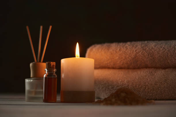 istock Towels, candle and massage oil on white table 1137891459
