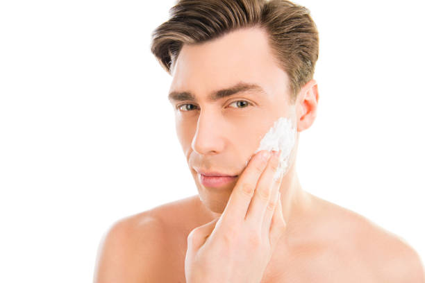 istock Handsome man smearing foam for shave on his face 1137893195