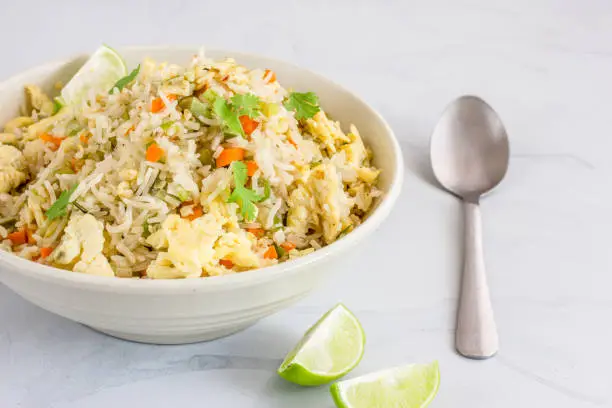 Chinese Style Egg Fried Rice with Vegetables in a  White Bowl. Asian Food, Chinese Food, Oriental Cuisine Concept.
