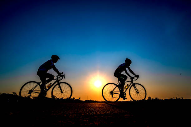 istock cyclist on sunset background 1137895118