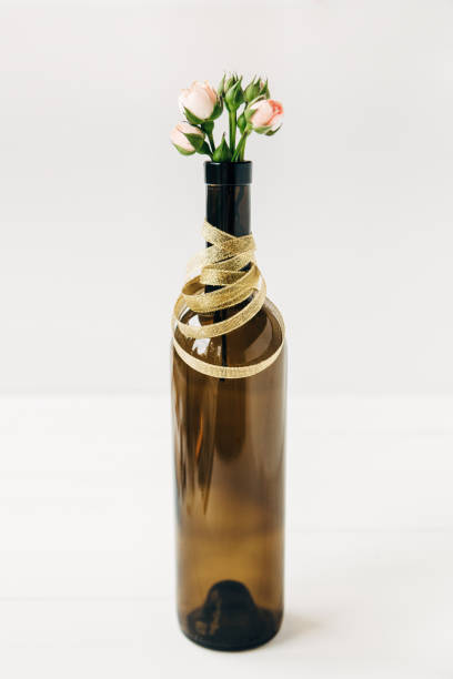 istock Creative floral composition with roses in bottle.Minimal concept.White background. 1137895420