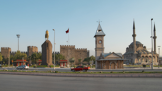 Kayseri, Turkey - July 27, 2007: Clock tower, monument to Ataturk, and Kayseri castle on Cumhuriyet Meydani square. Kayseri has outstanding Seljuk Turkish architecture