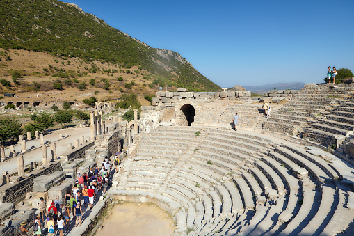 near Selcuk, Turkey - August 19, 2011: Tourists at the Odeon, the concert hall, or Bouleuterion, the senate meeting place, in the ancient Ephesus. Since 2015, Ephesus is listed as UNESCO World Heritage