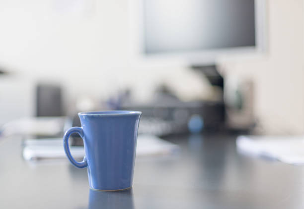 istock Blue cup of coffee on the office desk 1137897017