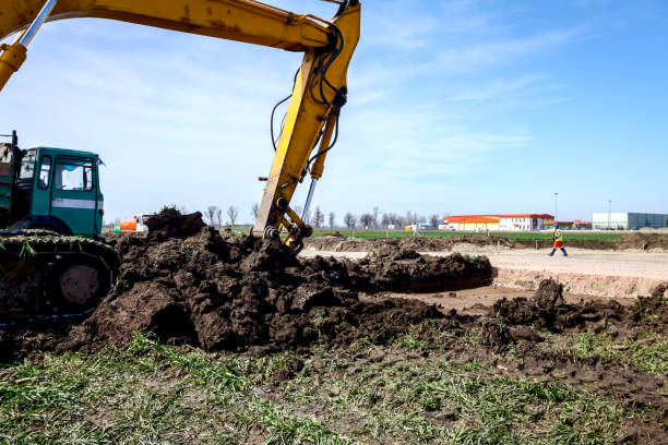 istock Excavator is loading a truck with ground on building site 1137900528