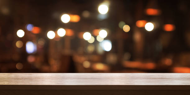 istock Empty wooden table top with blurred coffee shop or restaurant interior background. 1137901437