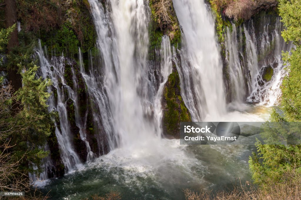 Close up of Burney Falls waterfall with Rainbow near Redding, in California Waterfall Stock Photo