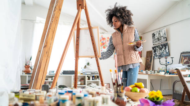 istock Young afro woman drawing 1137914553