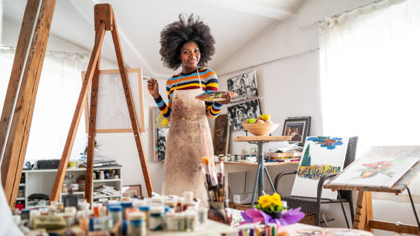 istock Young afro woman drawing 1137914560