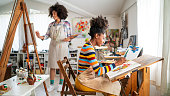 Afro Female fine artists drawing in studio
