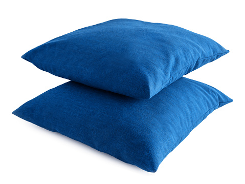 Two blue pillows against a white background