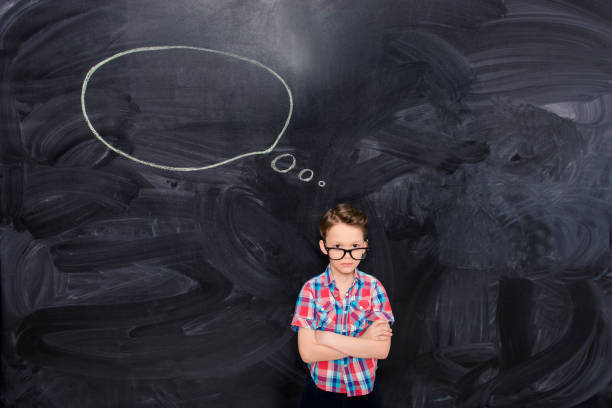 istock Portrait of young boy in glasses thinking about bright idea 1137916005