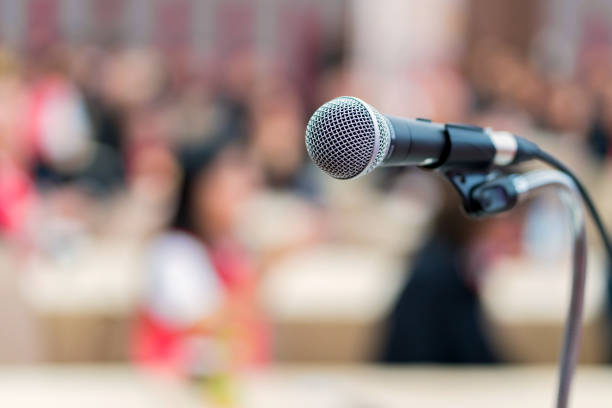 istock hand hold Microphone in meeting room for a conference 1137916405