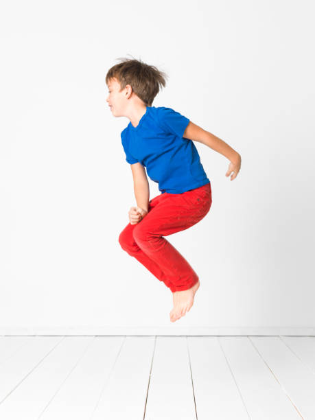 istock cool boy is jumping in front of white background 1137917751