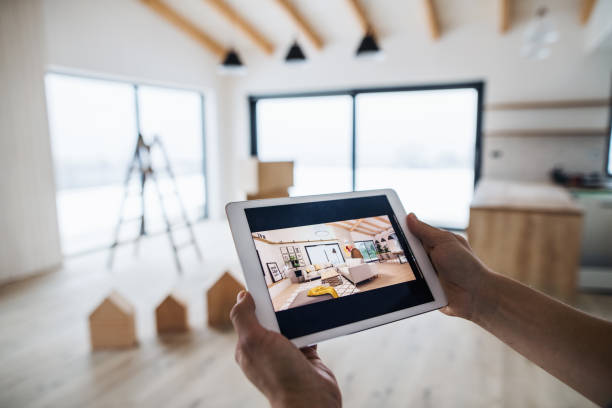 Midsection of man with tablet, looking at interior design sketches. A new home concept. A midsection of man with tablet, looking at interior design sketches. A new home concept. property styling stock pictures, royalty-free photos & images