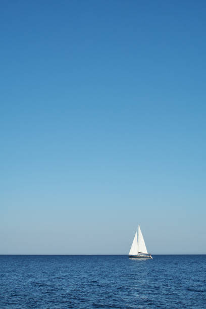 istock Sailing. Yachting. White boat with open sails sailing in the open blue sea 1137920020