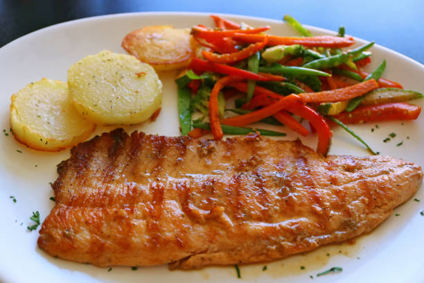 istock Plate of Peruvian Style Grilled Trout with Vegetable Saute 1137922393