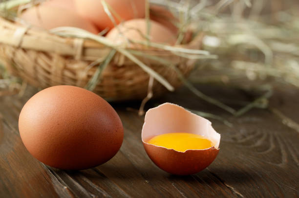 istock Broken egg with yolk and fresh brown organic eggs on wooden table 1137922620