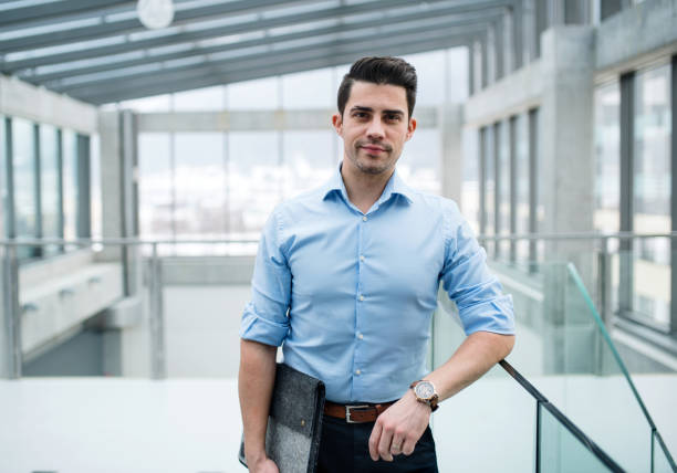 istock A young businessman standing in corridor outside office. 1137923383