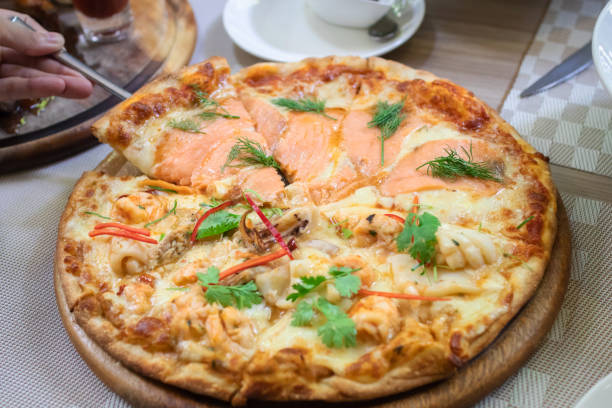 istock Salmon pizza half with spicy seafood. 1137923584