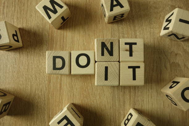 istock Don`t or do it text from wooden blocks 1137924824