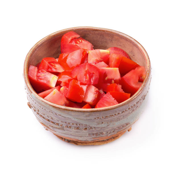 istock Chopped tomatoes in a bowl isolated on a white background 1137925432