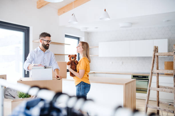 A young couple moving in new home.