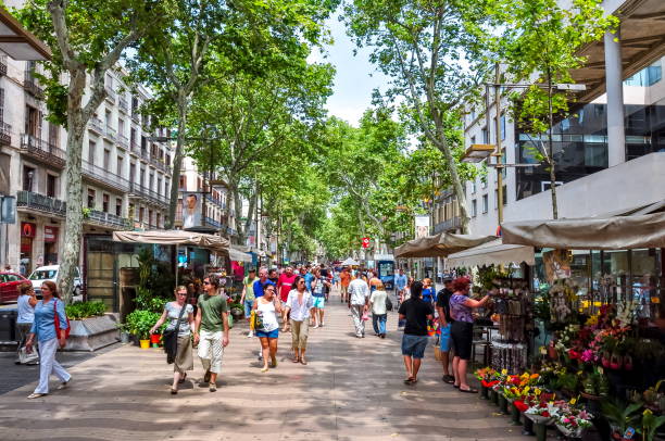 People walking on La Rambla (central street of Barcelona), Spain Barcelona, Spain - June 2018: People walking on La Rambla (central street of Barcelona) la rambla stock pictures, royalty-free photos & images