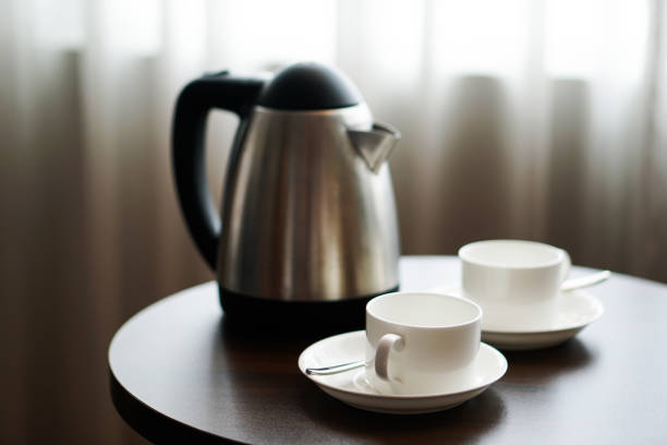 istock white tea cup coffee cup on the table by a sofa couch in hotel room, kettle 1137929187