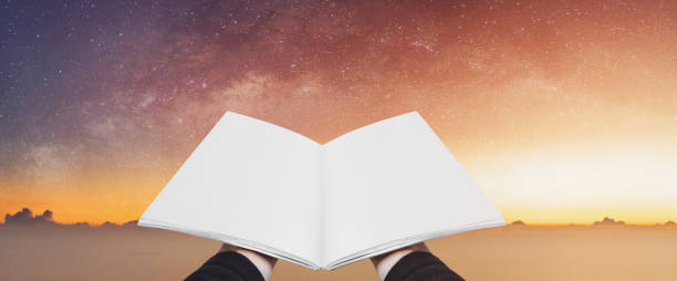 istock Hand holding opened book, blank pages on colorful starry sky. Concepts of imagination, knowledge, wisdom and education 1137931153