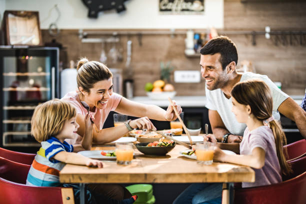 istock Happy family talking while having lunch in dining room. 1137934168