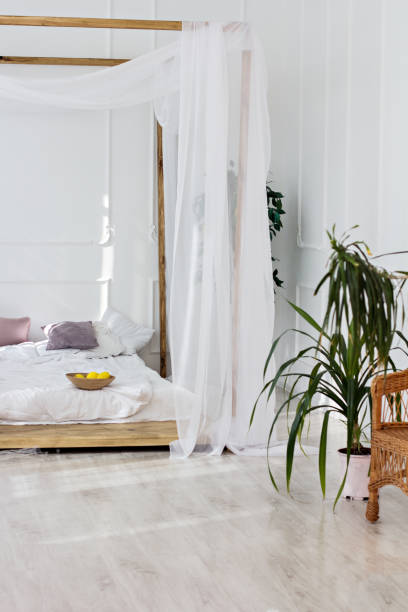 Beautiful bright room and a four-poster bed.