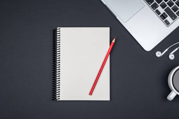 istock Minimal workplace with laptop and blank notepad on colored background. Top view. Flat lay 1137935072