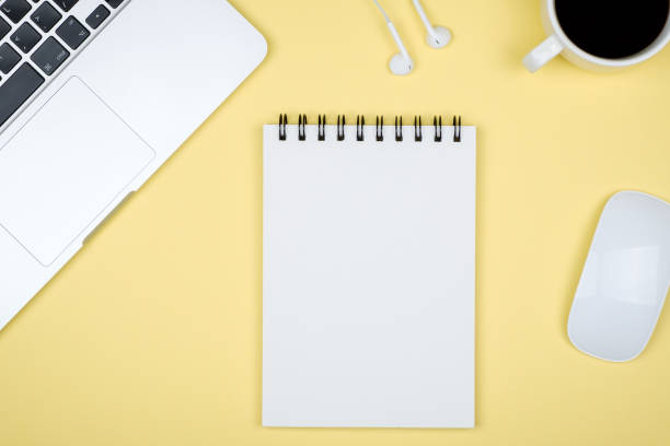 istock Minimal workplace with laptop and blank notepad on colored background. Top view. Flat lay 1137935165
