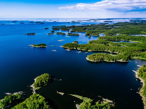 Aerial view of blue lakes and green forests on a sunny summer day in rural Finland. Drone photography from above