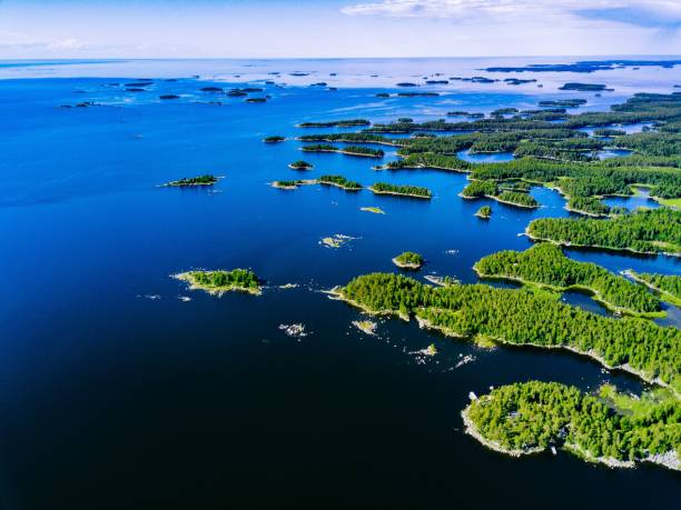 Aerial view of blue lakes and green forests on a sunny summer day in rural Finland. Aerial view of blue lakes and green forests on a sunny summer day in rural Finland. Drone photography from above åland islands stock pictures, royalty-free photos & images