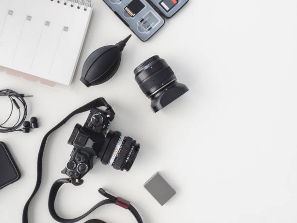 istock top view of work space photographer with digital camera, flash, cleaning kit and memory card on white table background. 1137938570