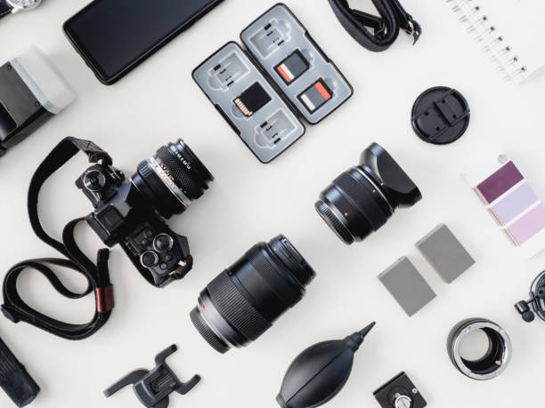 istock top view of work space photographer with digital camera, flash, cleaning kit and memory card on white table background. 1137938598