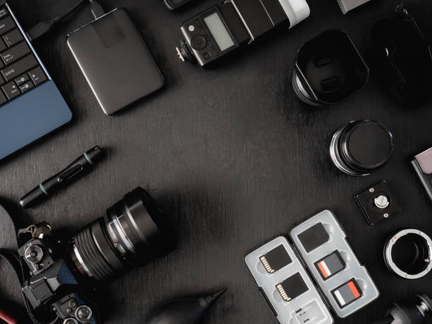 istock top view of work space photographer with digital camera, flash, cleaning kit, memory card, external harddisk, USB card reader, laptop and camera accessory on black table background 1137938601