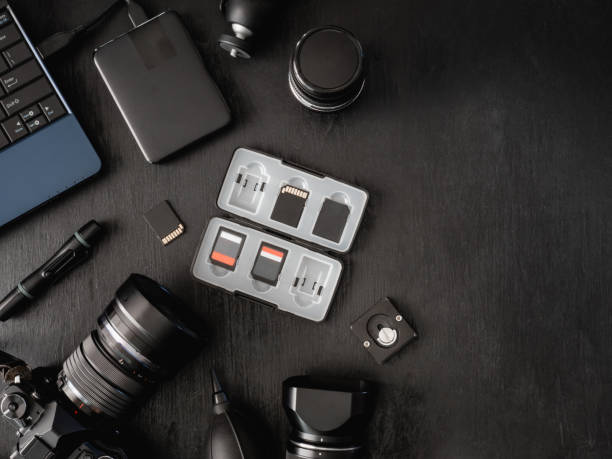 istock top view of work space photographer with digital camera, flash, cleaning kit, memory card, external harddisk, USB card reader, laptop and camera accessory on black table background 1137938605