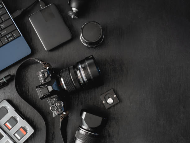 istock top view of work space photographer with digital camera, flash, cleaning kit, memory card, external harddisk, USB card reader, laptop and camera accessory on black table background 1137938645