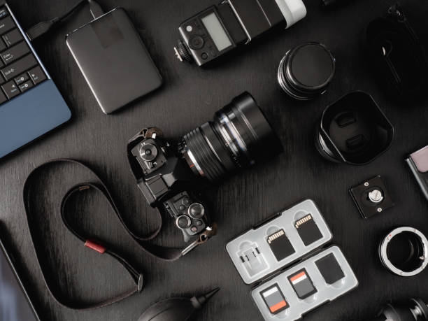 istock top view of work space photographer with digital camera, flash, cleaning kit, memory card, external harddisk, USB card reader, laptop and camera accessory on black table background 1137939163