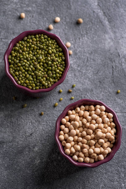 istock Mung beans and chickpeas in bowls. Kitchen table top view 1137940369