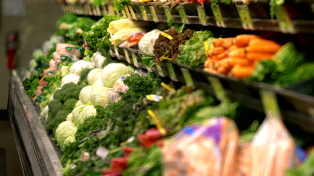 Organic vegetables on the shelves of supermarket in 4k slow motion 60fps