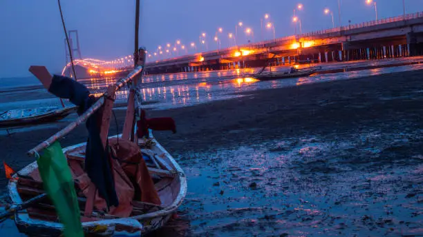 Majority of small boats in madura strait around suramadu bridge were operated after dawn. This picture was captured at dawn, when sunrise start coming.