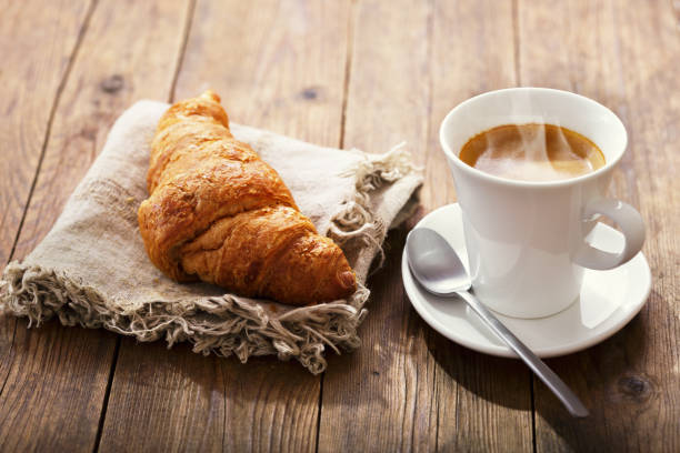 istock cup of coffee and croissant 1137945192