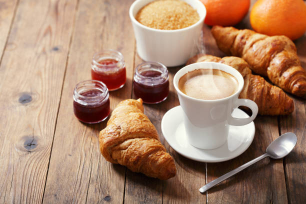 istock cup of coffee and croissants with fruit jam 1137945196